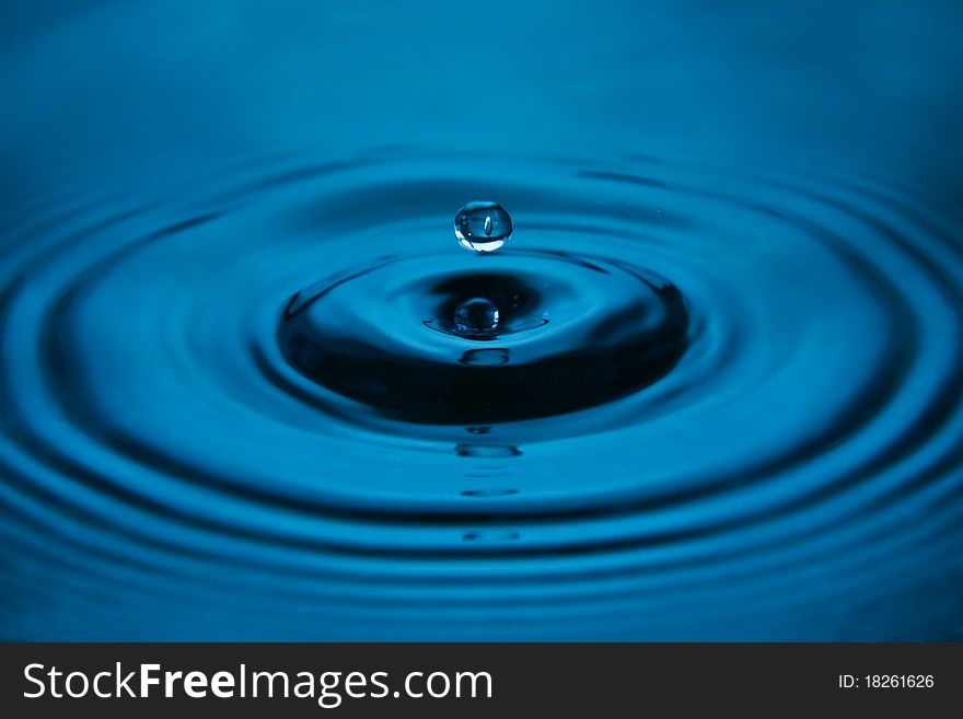 Blue water drop close up