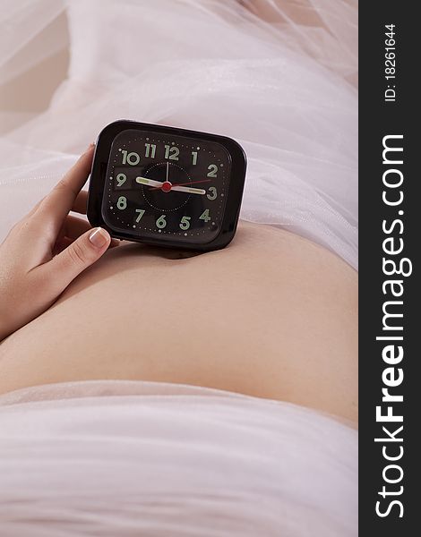 Mother expecting baby has a watch