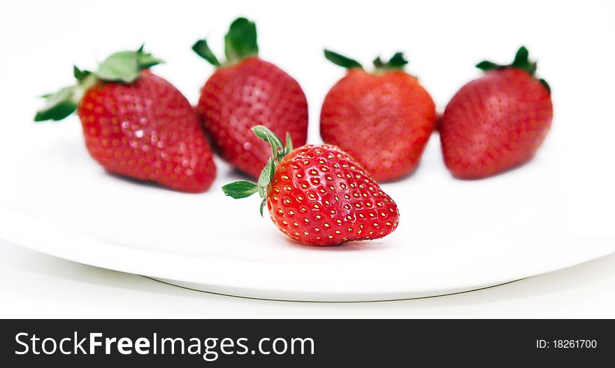 Isolated fruits - Strawberries on white plate.