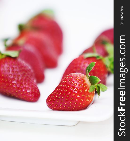 Isolated fruits - Strawberries on white plate.