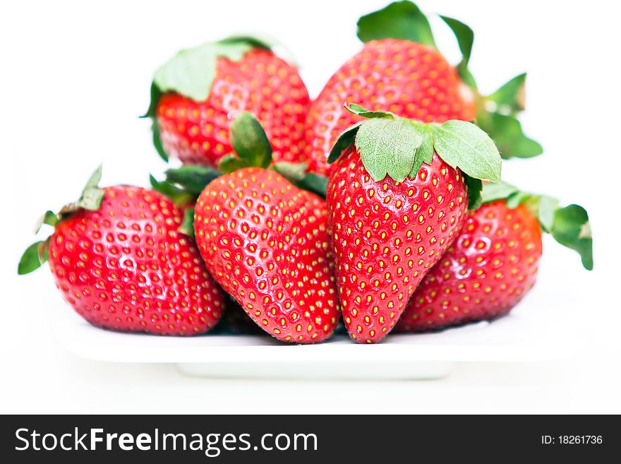 Isolated fruits - Strawberries on white plate.