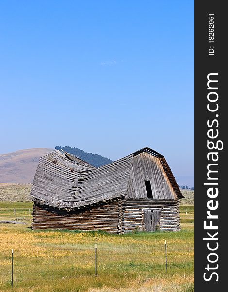 Old barn in western Montana with roof caving in. Old barn in western Montana with roof caving in.