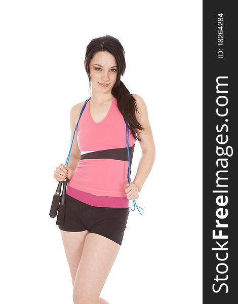 A woman is holding a jump rope around her neck. A woman is holding a jump rope around her neck.