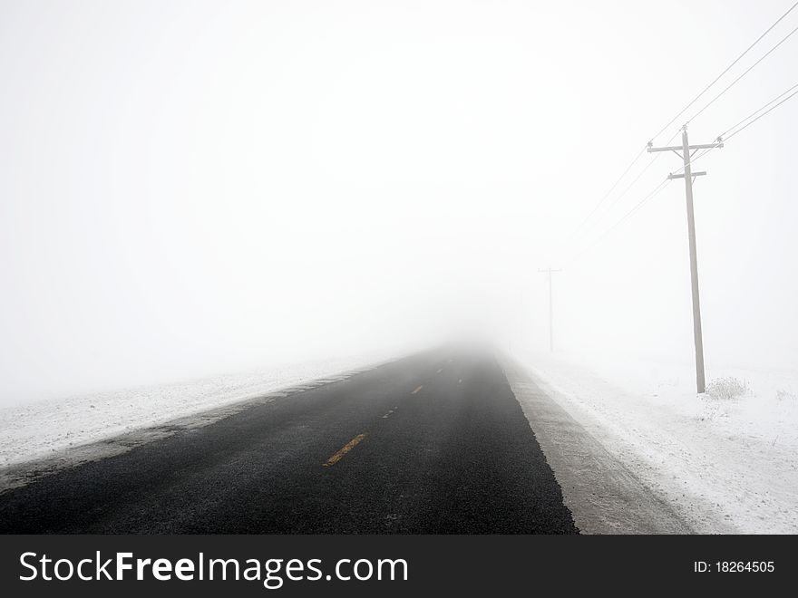 Snowbound Blacktop Road Into White Out Storm