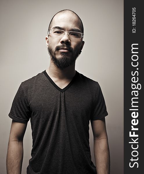 Asian man with glasses against a plane back ground