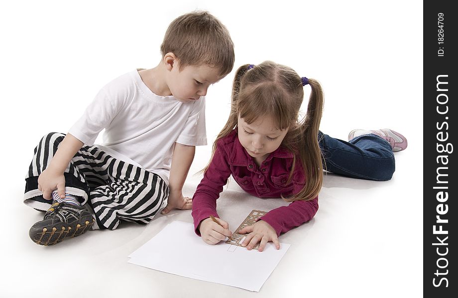Brother sits and his elder sister draws on a ruler. Brother sits and his elder sister draws on a ruler