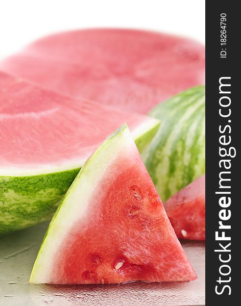 Fresh sliced watermelon on a cutting board, white background with copy space