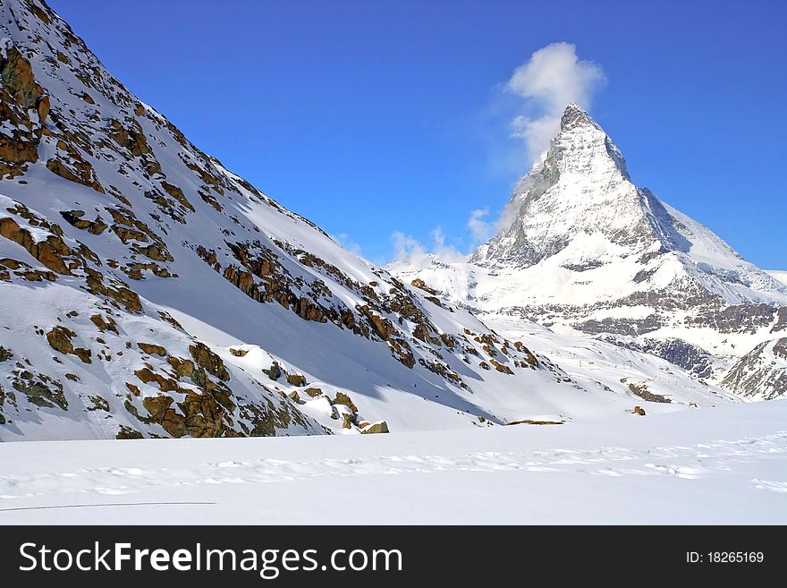 Matterhorn Peak in Swiss Alps with red rock landscape