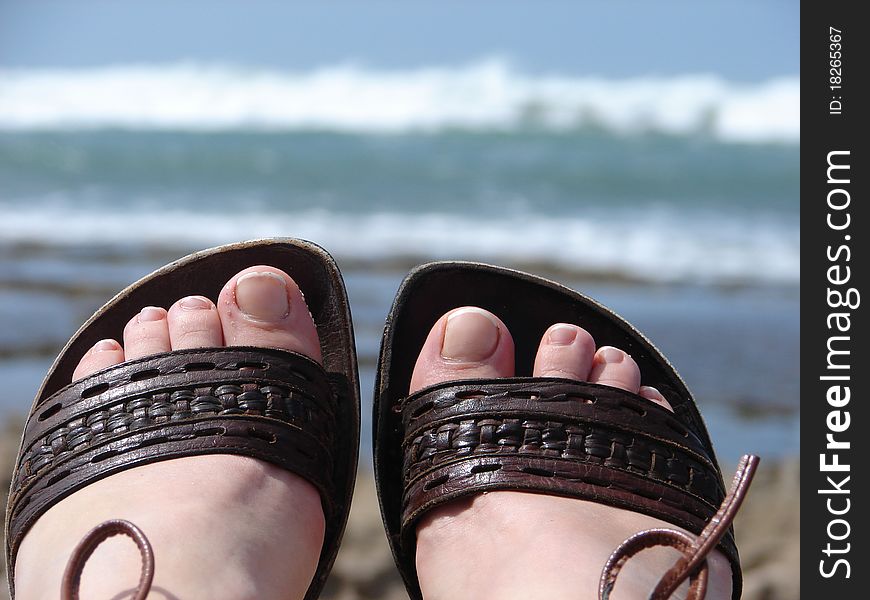 Sandals on the beach in vacation time. Holidays at the beach.