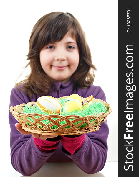 Little girl with easter eggs in a punnet