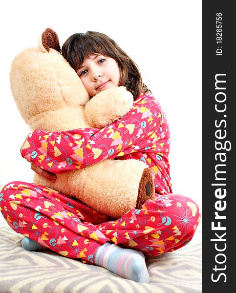 Little girl with toy bear isolated on a white background