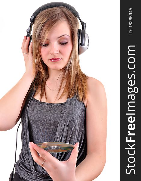 Girl with headphones looking at the cd isolated over white background
