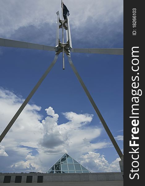 Clouds gather under flag pole on top of Australia's House of Parliament, Canberra. Clouds gather under flag pole on top of Australia's House of Parliament, Canberra.