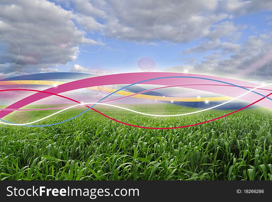 A beautiful green field under a blue sky with multicolored glowing lines. A beautiful green field under a blue sky with multicolored glowing lines