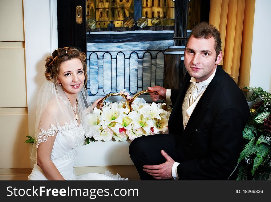 Happy bride and groom with big wedding rings