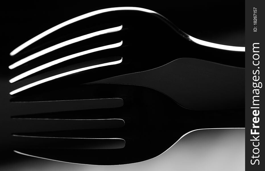 Low key image of a domestic fork with reflection