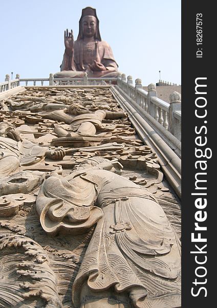 Figure stucco in front of Guan Yin Buddha Statue