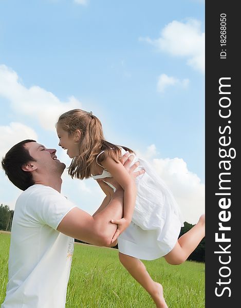 Father and daughter playing in the meadow