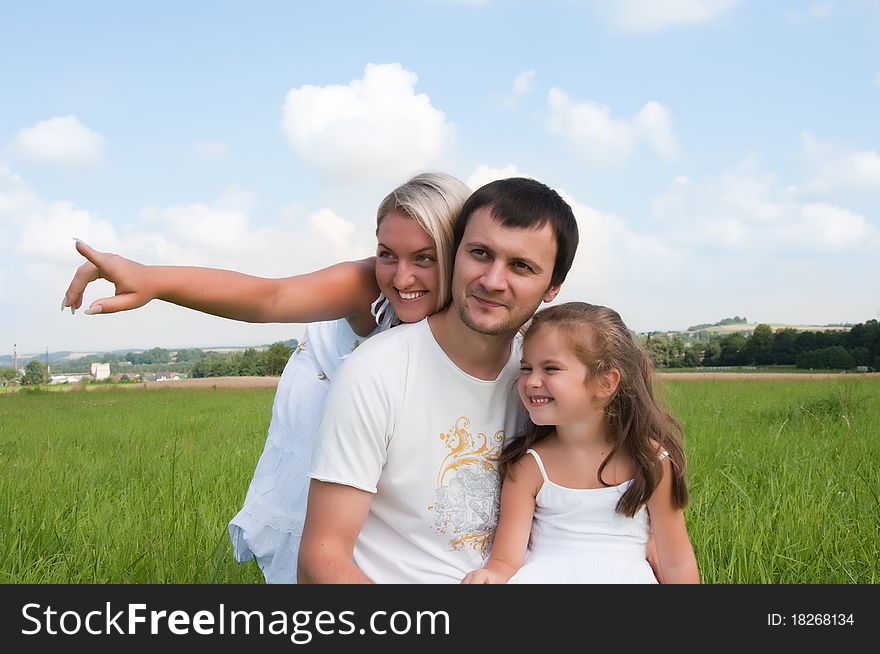 Happy family enjoy on the meadow