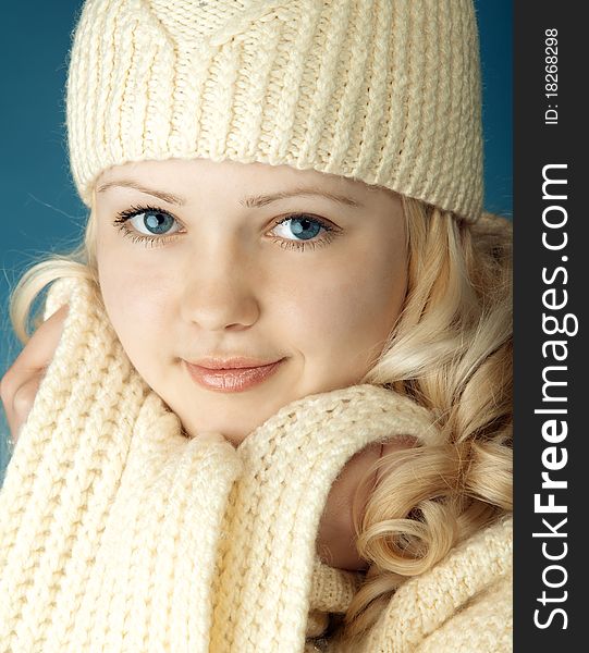 Young girl with scarf in front of the blue background