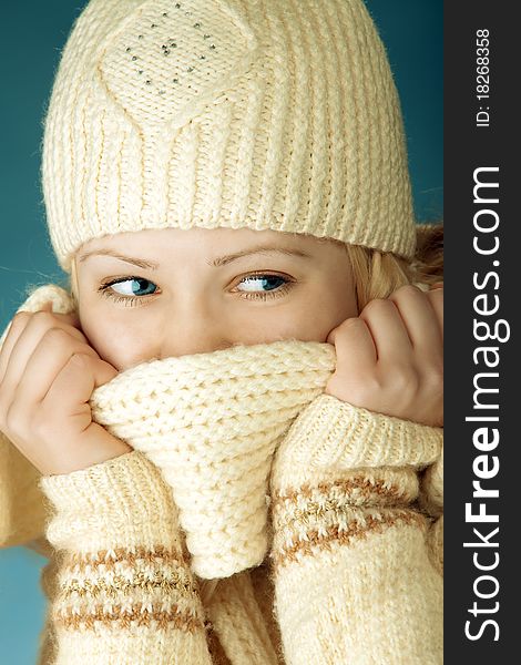 Young girl with scarf in front of the blue background