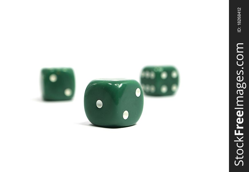 Three green dices on a white background