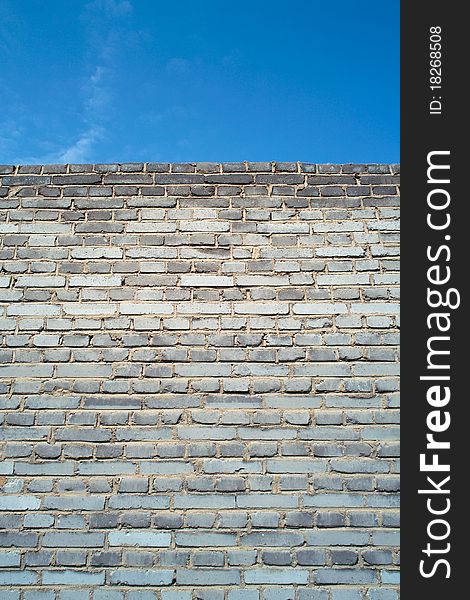 Brick wall under blue sky