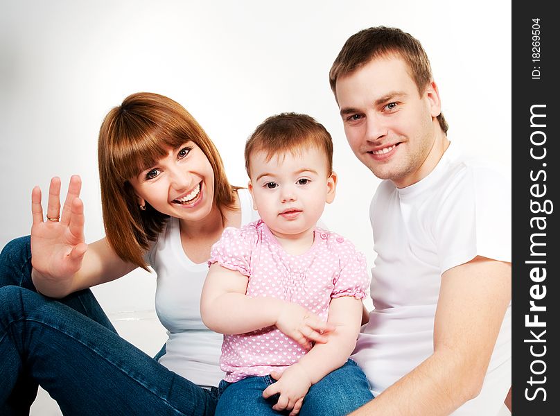 Happy family with a baby on a white background