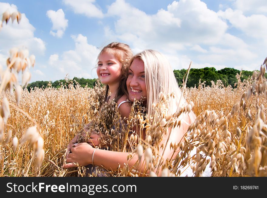 Mother and daughter in summer field