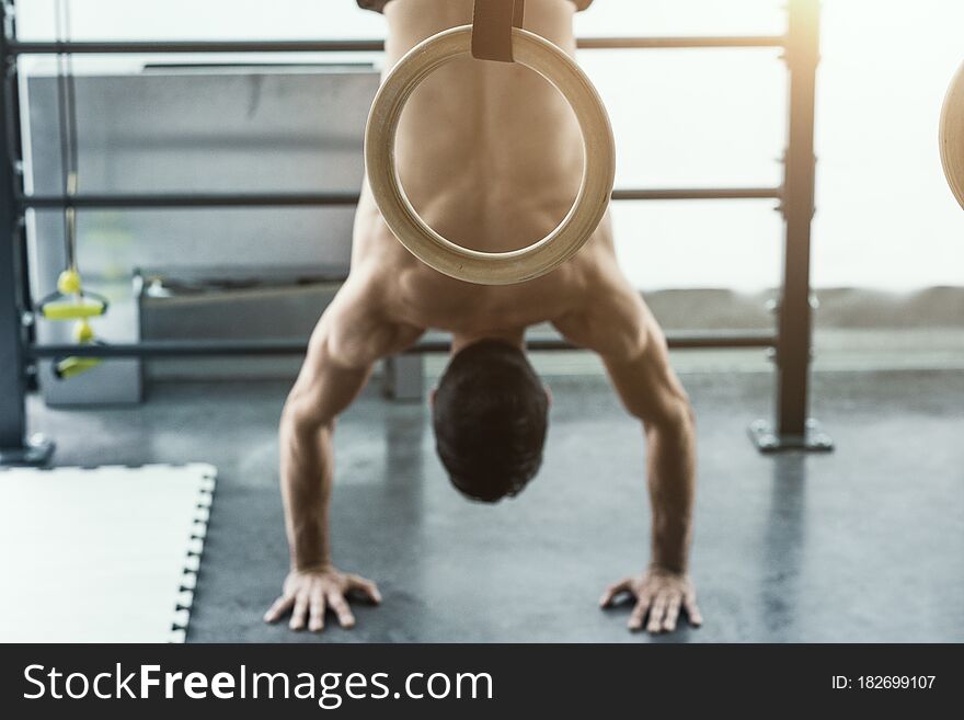 Athletic fit man exercising at the gym and doing a handstand, fitness and balance concept. Athletic fit man exercising at the gym and doing a handstand, fitness and balance concept