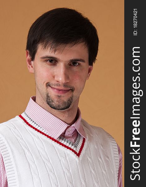 Young man with beard looking at photographer and smiling