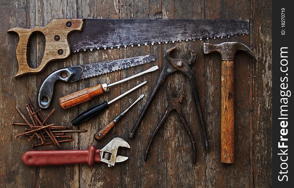 Old tools against wooden wall