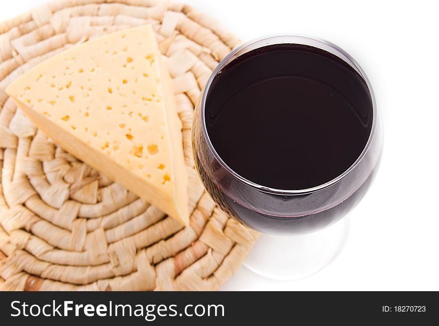 Red wine glass with cheese, upper view