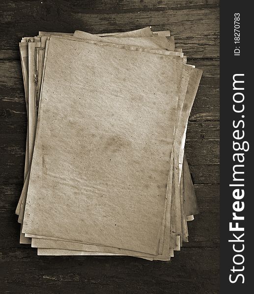 Stack of old papers on wooden background