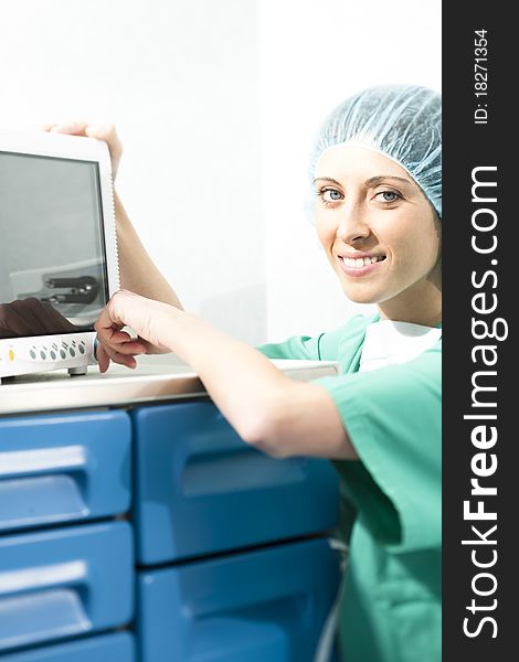 Female surgeon using monitor in operating room