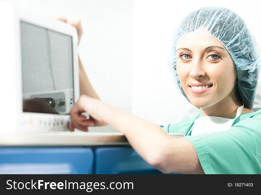 Female surgeon using monitor in operating room