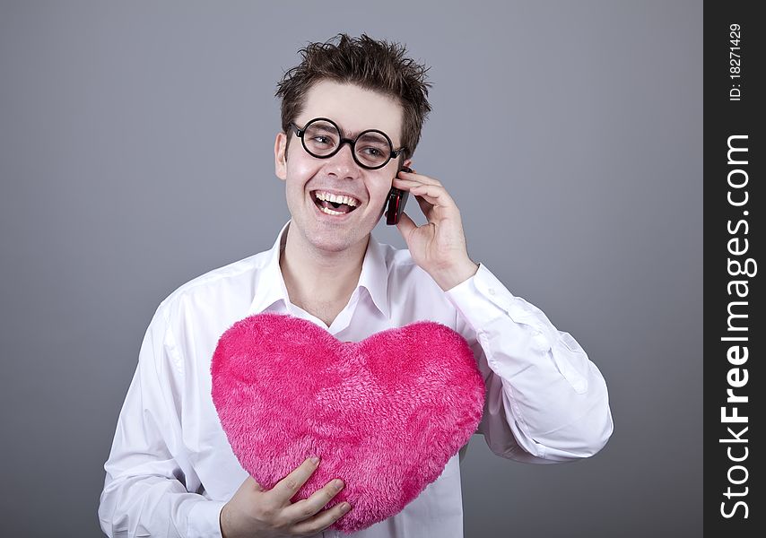 Funny men with toy heart. Studio shot.