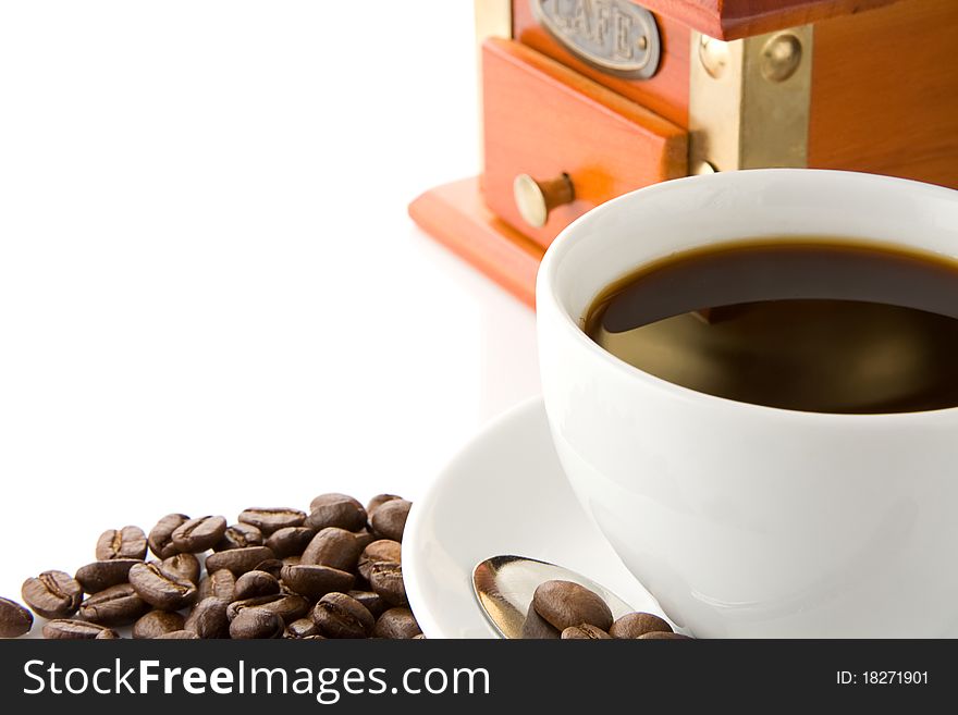 Cup of coffee, grinder and beans isolated on white background