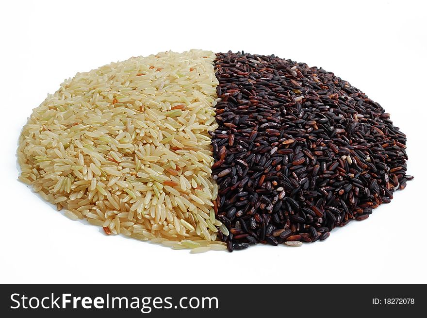 Isolated brown and black indica rice on white background