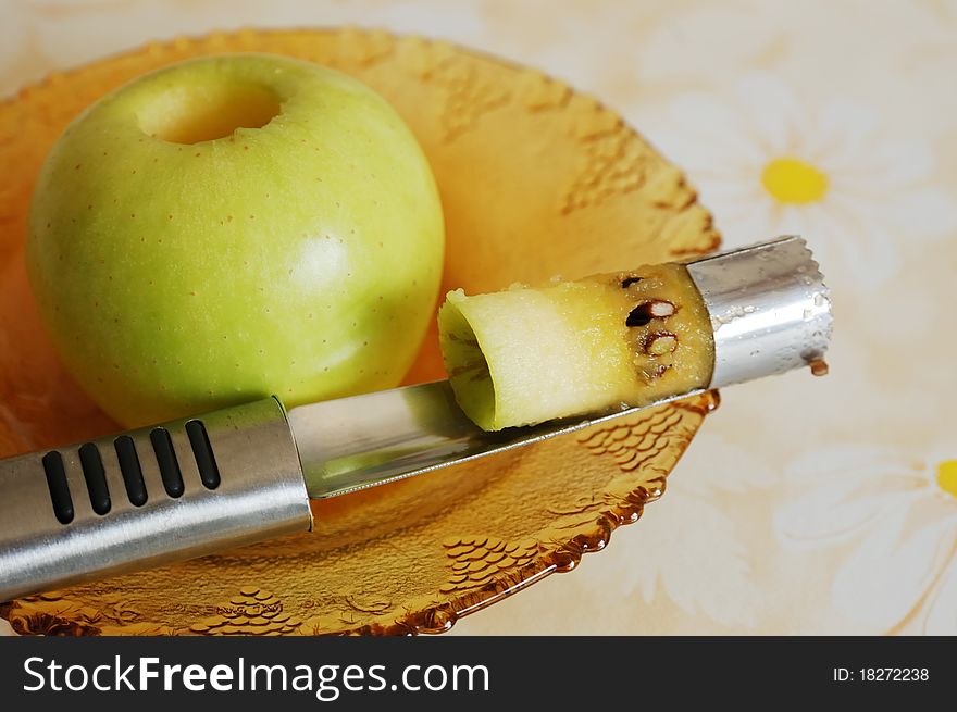 Taking out an apple core. apple and corer on a saucer