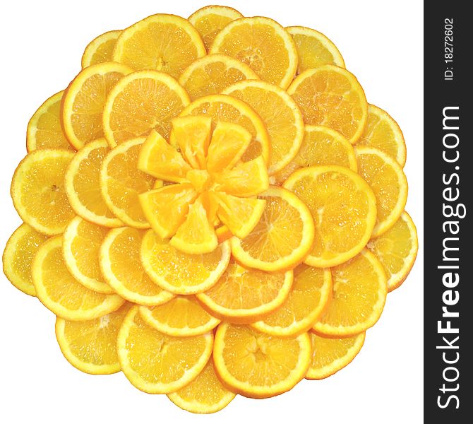 Oranges cut on segments and laid out by a flower as a still-life