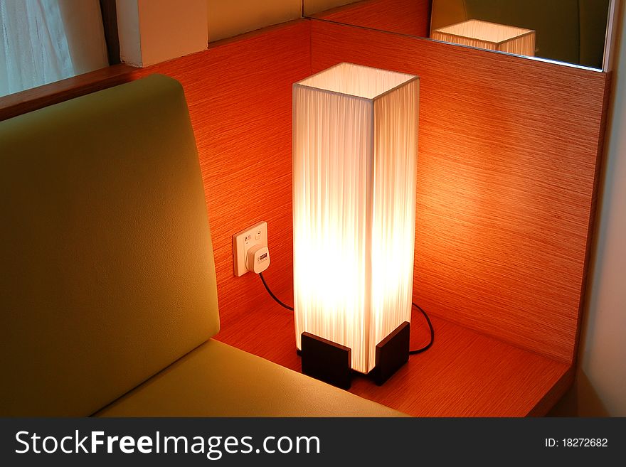 Designer tower table lamp illuminating a room