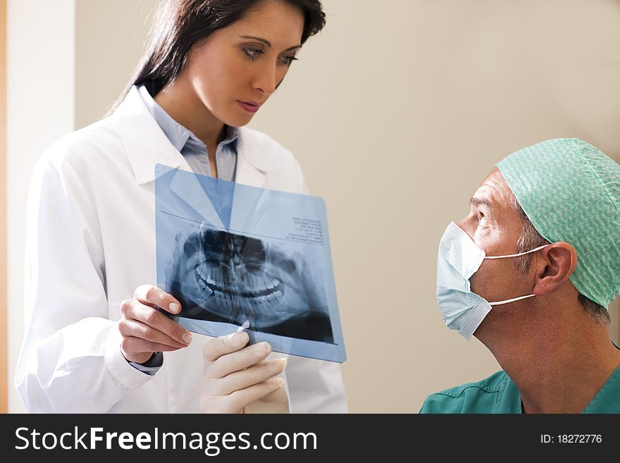 Two Dentists examining x-ray. Two Dentists examining x-ray