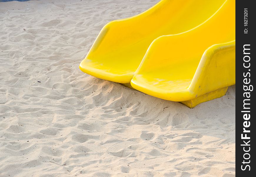 Two slider on a sand playground