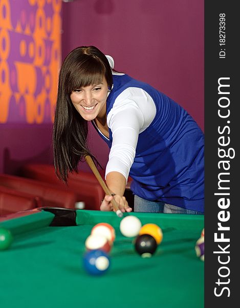 Photo of young woman during snooker game. Photo of young woman during snooker game.