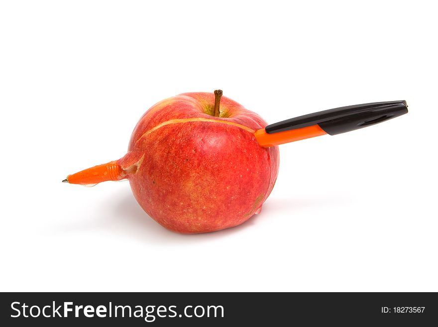 Red apple on a white background pierced by a pen. Isolated on white background.