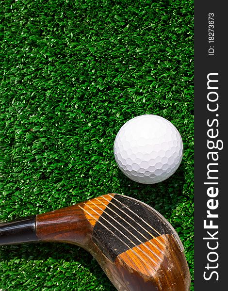 Golf Ball and driver on green grass