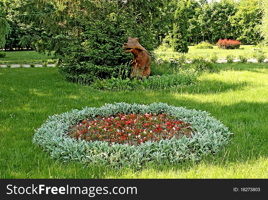 Wooden bear, beautiful landscape, fervent summer