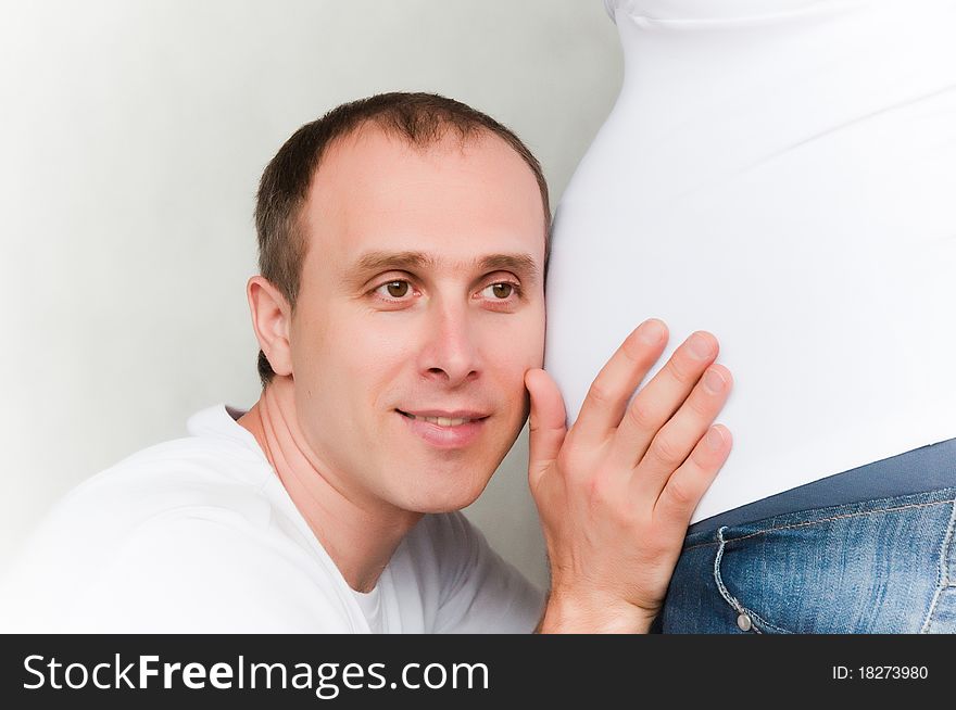 Happy young pregnant couple at home. Happy young pregnant couple at home