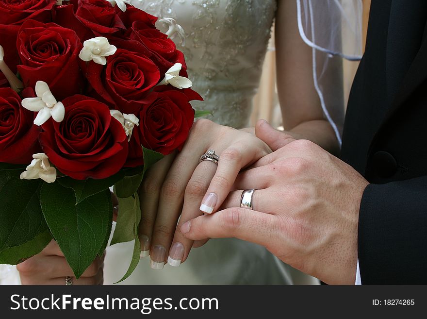 A Bride and Groom showing their rings together. A Bride and Groom showing their rings together.